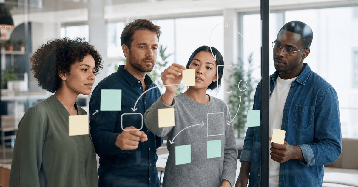 A small team planning an AI automation project around a whiteboard