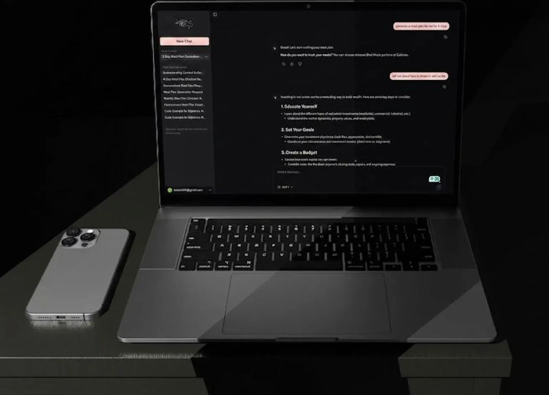 Laptop on a dark desk showing a chat conversation generating a plan, next to a phone