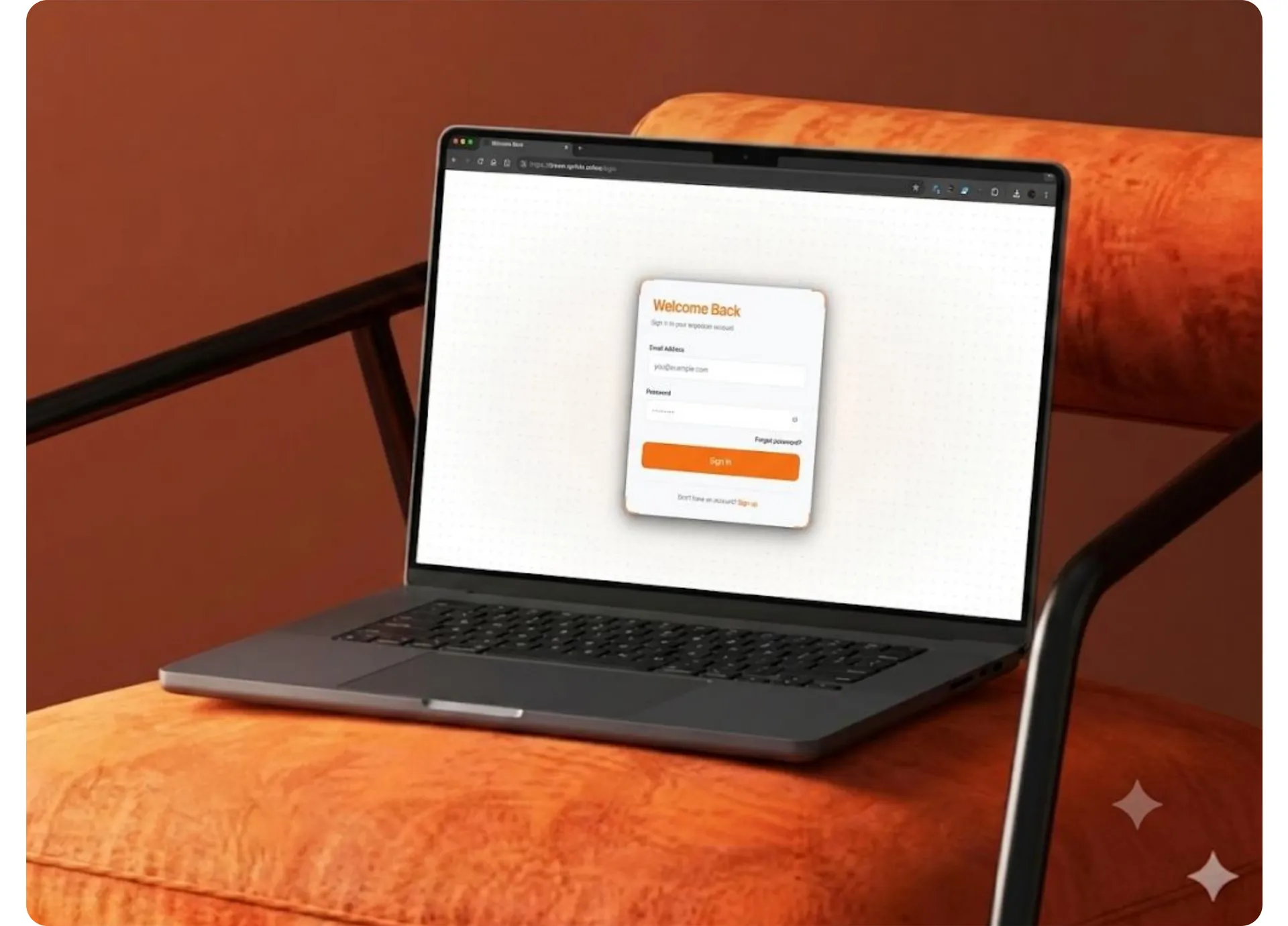 Sign-in screen on a laptop resting on an orange armchair