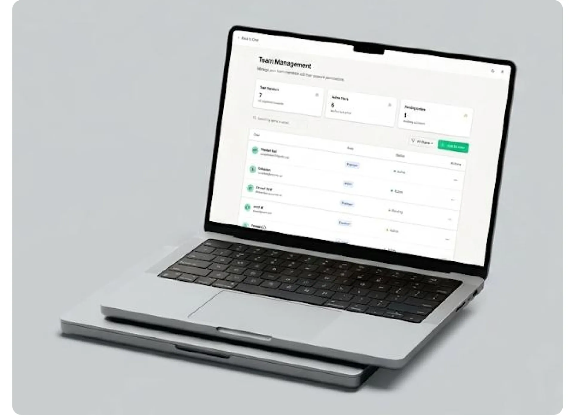 Laptop showing a team management screen with member list and roles
