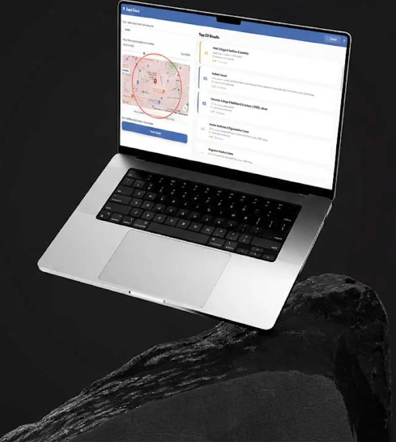 Laptop on a dark rock showing ranked local results next to a map radius