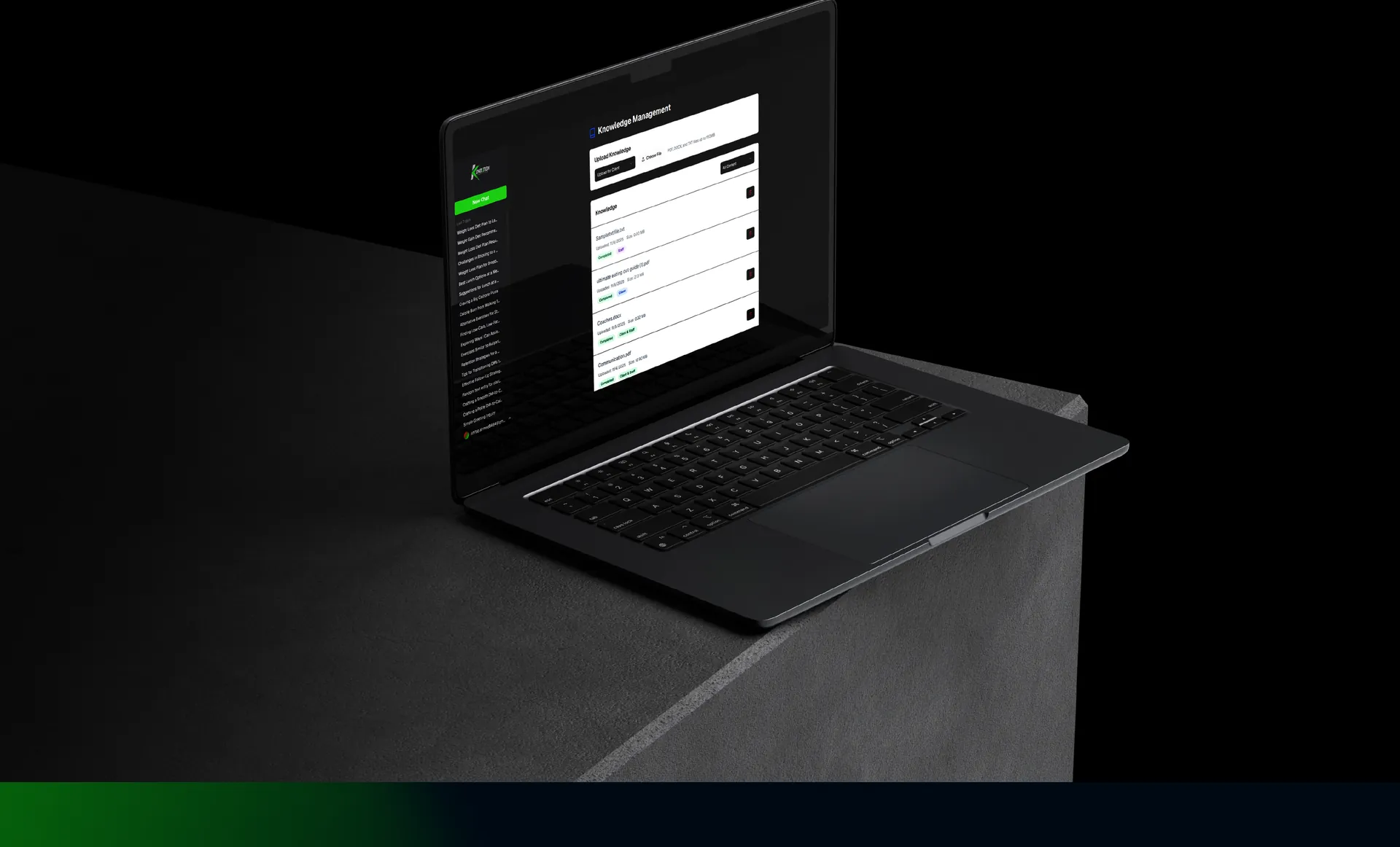 Laptop on a dark plinth showing a knowledge management screen for uploading guides