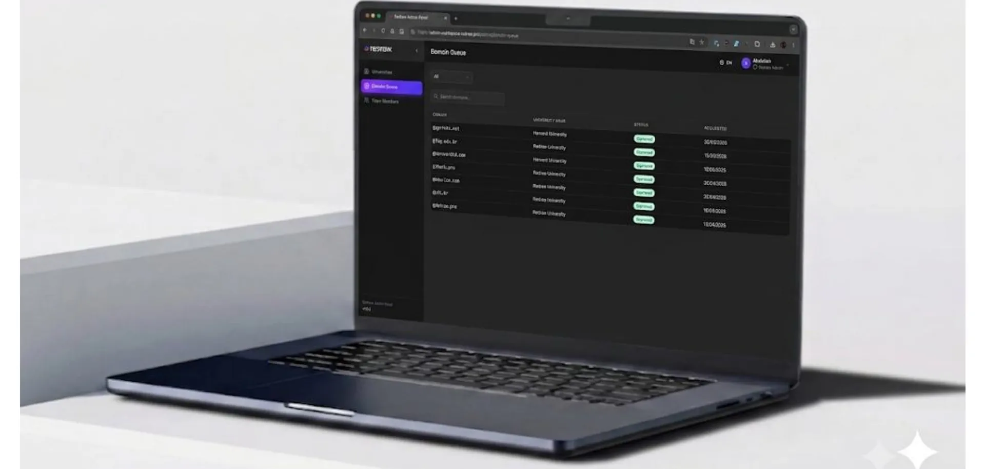 Laptop showing a dark table of email domains with active status badges