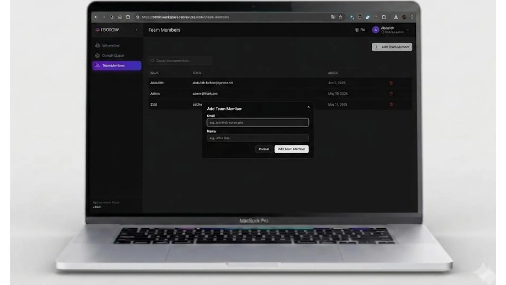 Laptop showing a dark team members screen with an add team member dialog
