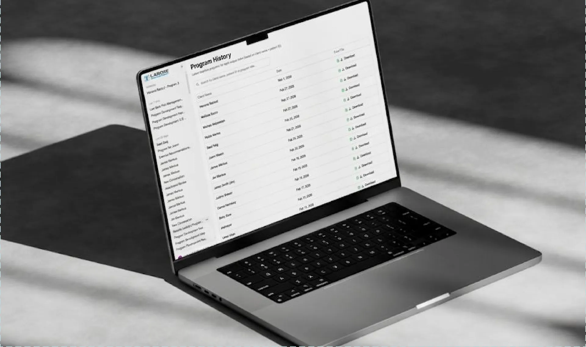 Laptop showing a program history table with download links for each exercise program